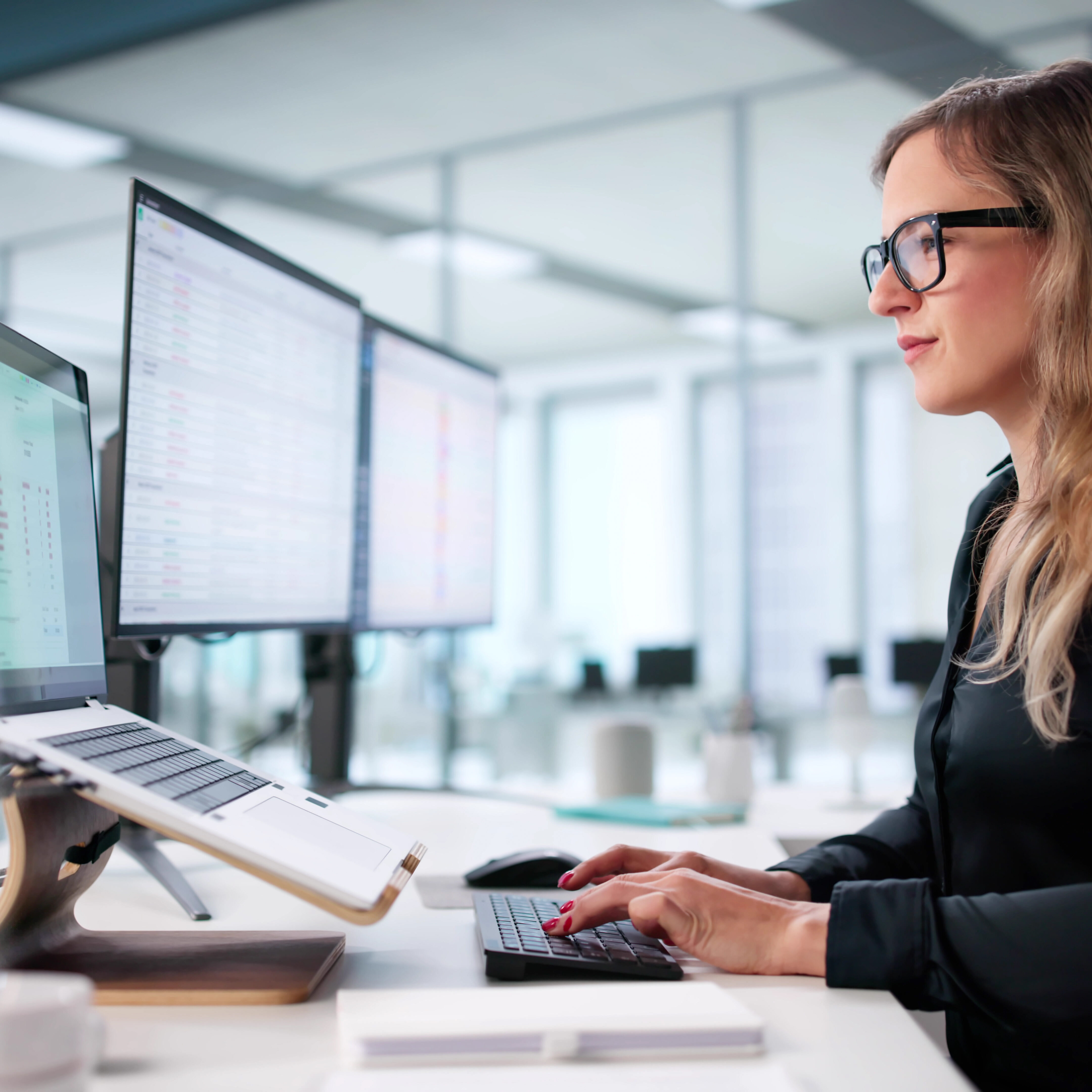 Young Woman Manages Medical Billing Audit Using Computer Codes Effectively.