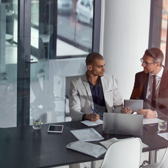 Business team, tablet and planning collaboration online for finance strategy or partnership. Management men together in a meeting discussion with documents and internet for tax audit report in office.